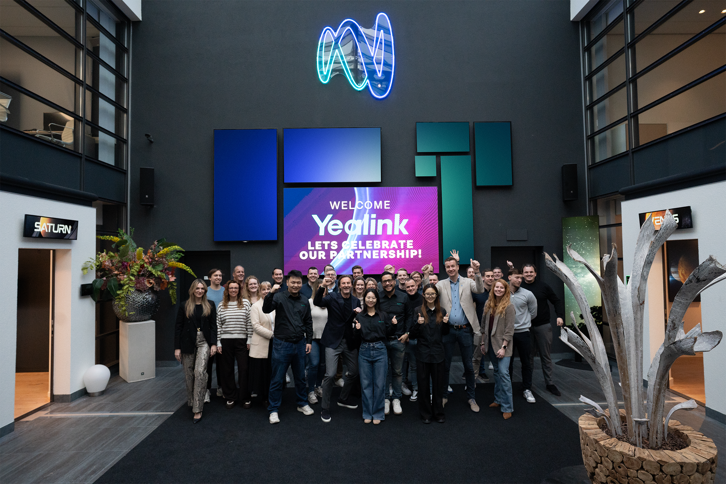 a group of people standing in a large group in a building